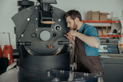 12 male worker in uniform repairing a coffee roasting 12-male-worker-in-uniform-repairing-a-coffee-roasting